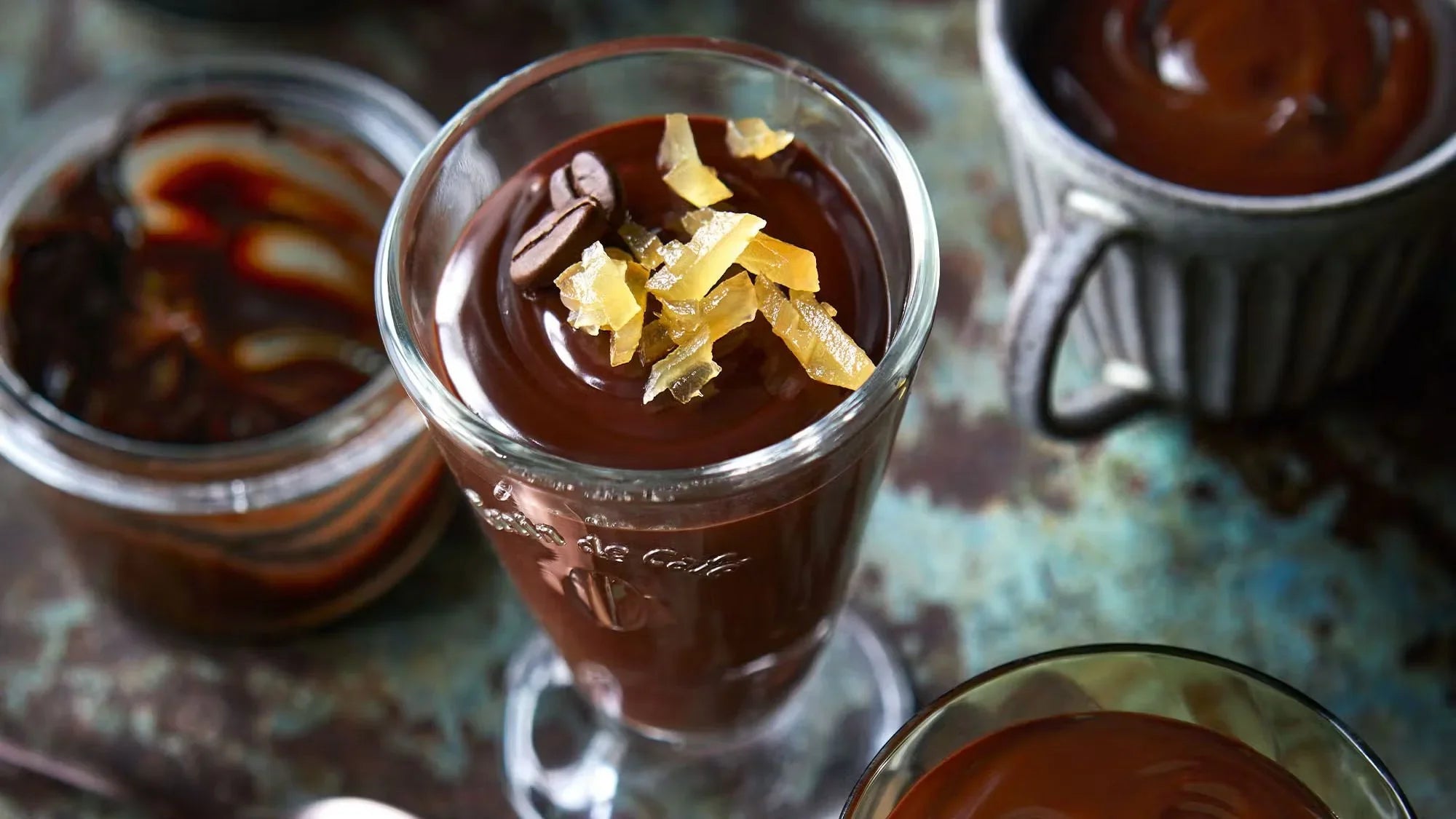 Chocolate coffee ginger ganache pots in glass, garnished with candied ginger and coffee beans