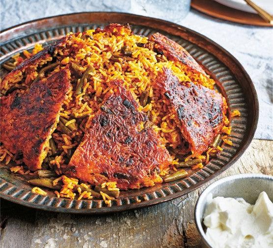 Persian Lubia Polo with crispy tahdig rice crust and green beans on a rustic plate