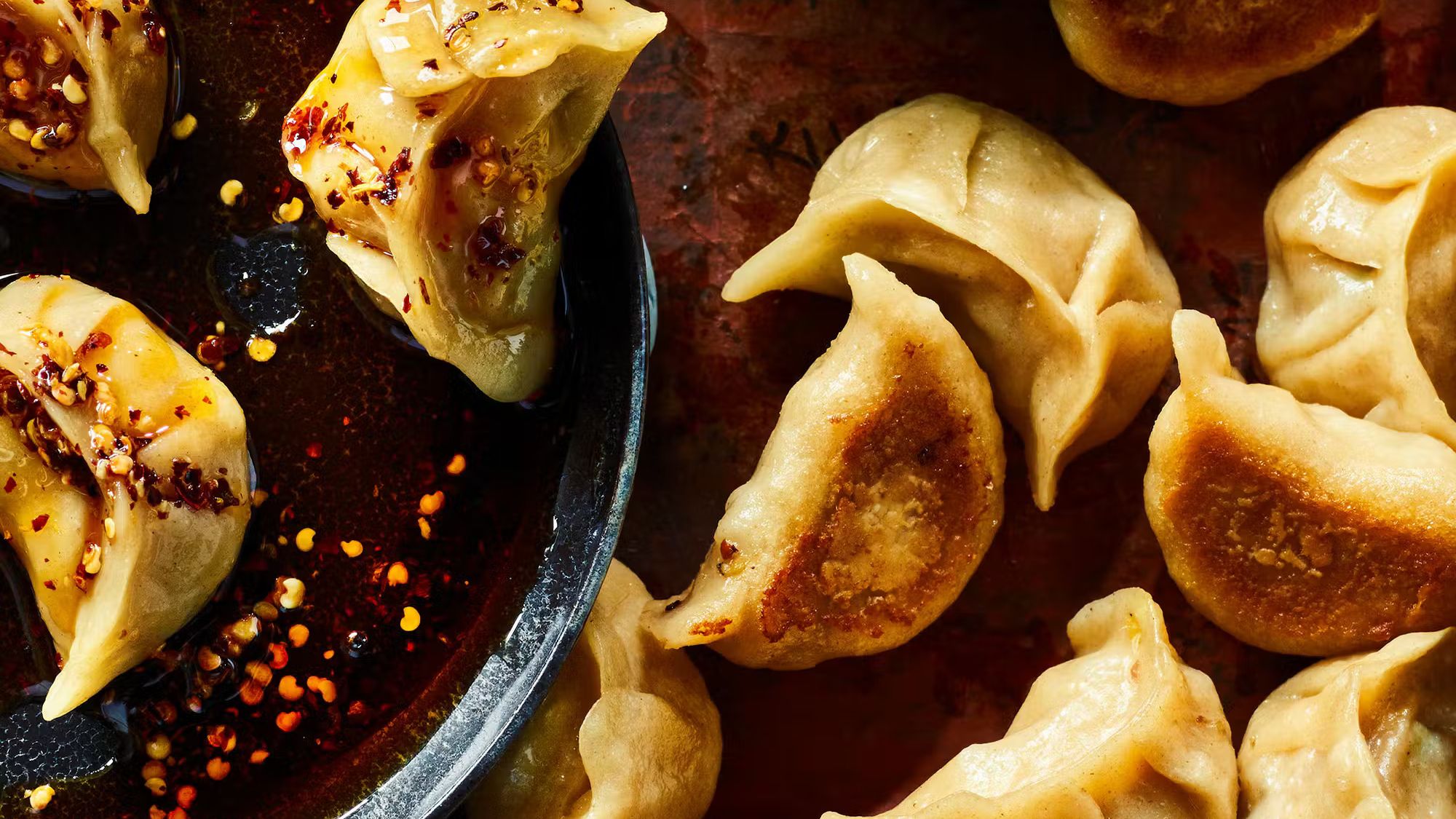Pan-fried Beijing dumplings with crispy bottoms and chili oil dipping sauce