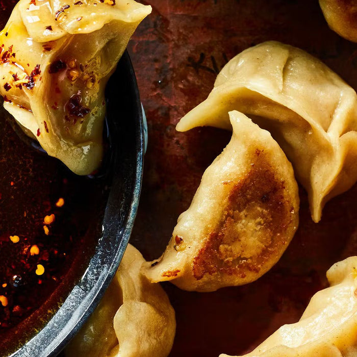 Pan-fried Beijing dumplings with crispy bottoms and chili oil dipping sauce