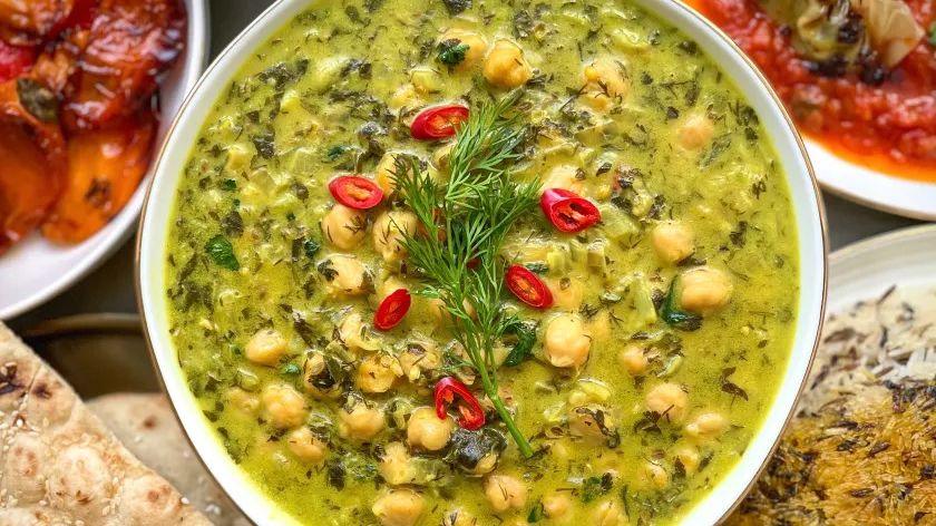 Coconut and herb chickpea curry spread topped with fresh dill and sliced red chili