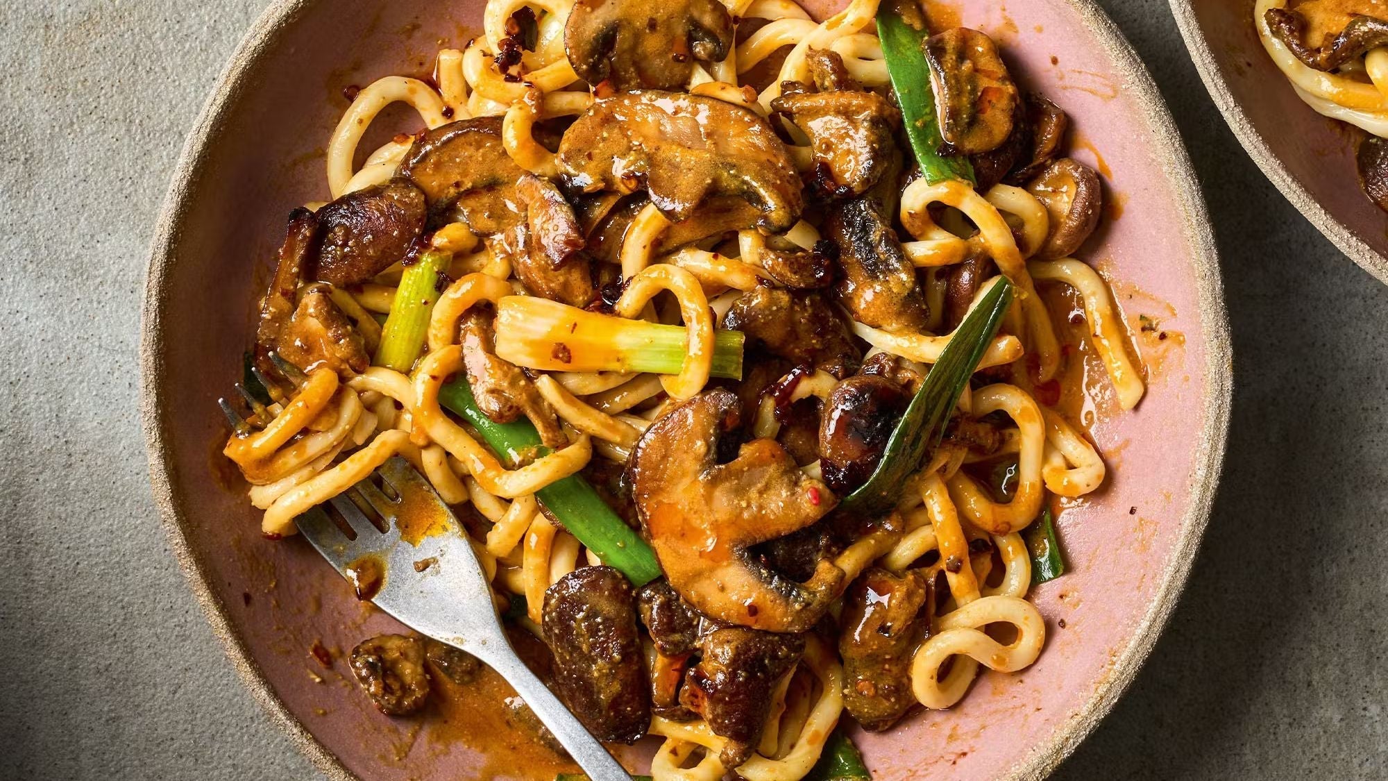Bowl of miso and chilli mushroom noodles with scallions and savory sauce