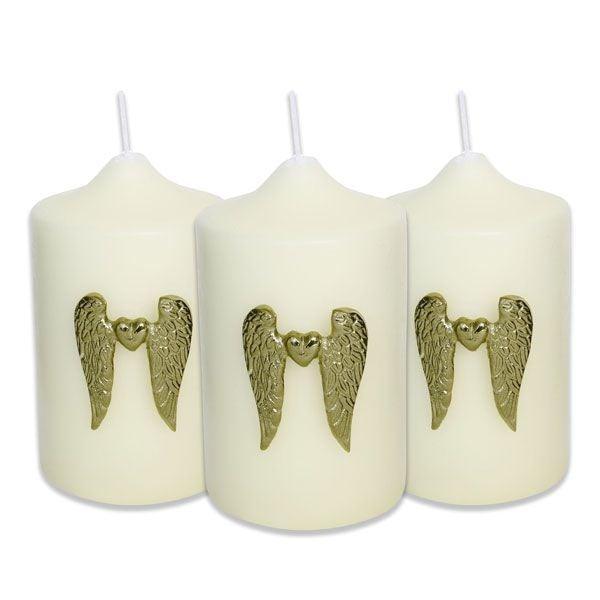 Set of three white pillar candles with gold wing and heart embellishments, decorative home decor