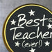 imgi_11_lily-flame-best-teacher-ever-scented-candle-tin-1733852635Best-Teacher-Lid1